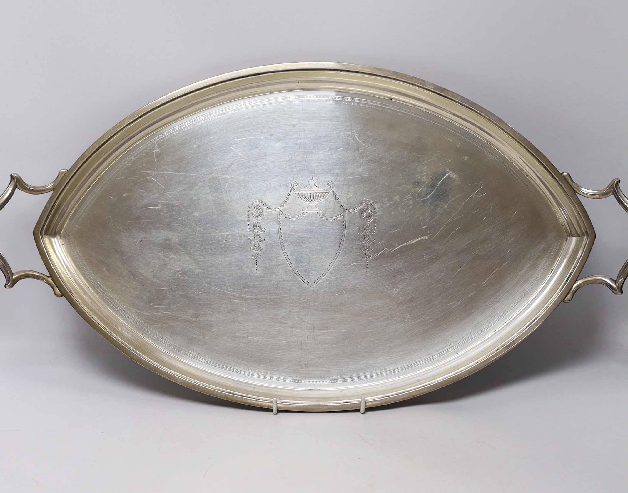 A George V silver elliptical two handled tea tray, Edward Barnard & Sons, London, 1911, 62.6cm over handles